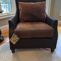 dark brown woven wicker armchair with brown cushions