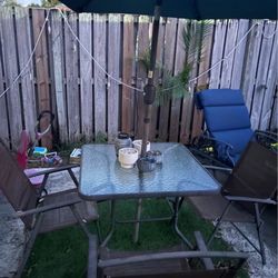 two chairs and table and sun protector 