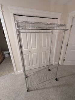Rolling metal coat rack