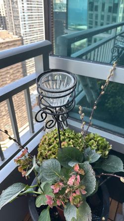Garden glass votive on a wrought iron on a stake