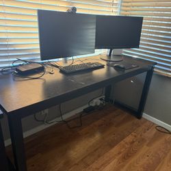 Two (2), Six (6) Foot, Black Desks & One (1) Office Chair
