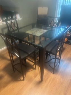 Metal table with glass tops and tile chairs design