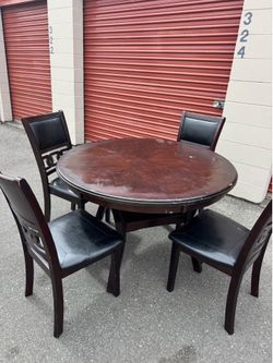 Round wooden table and four chairs