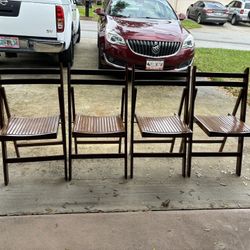 Four Wooden Folding Chairs made in Romania. Excellent condition.