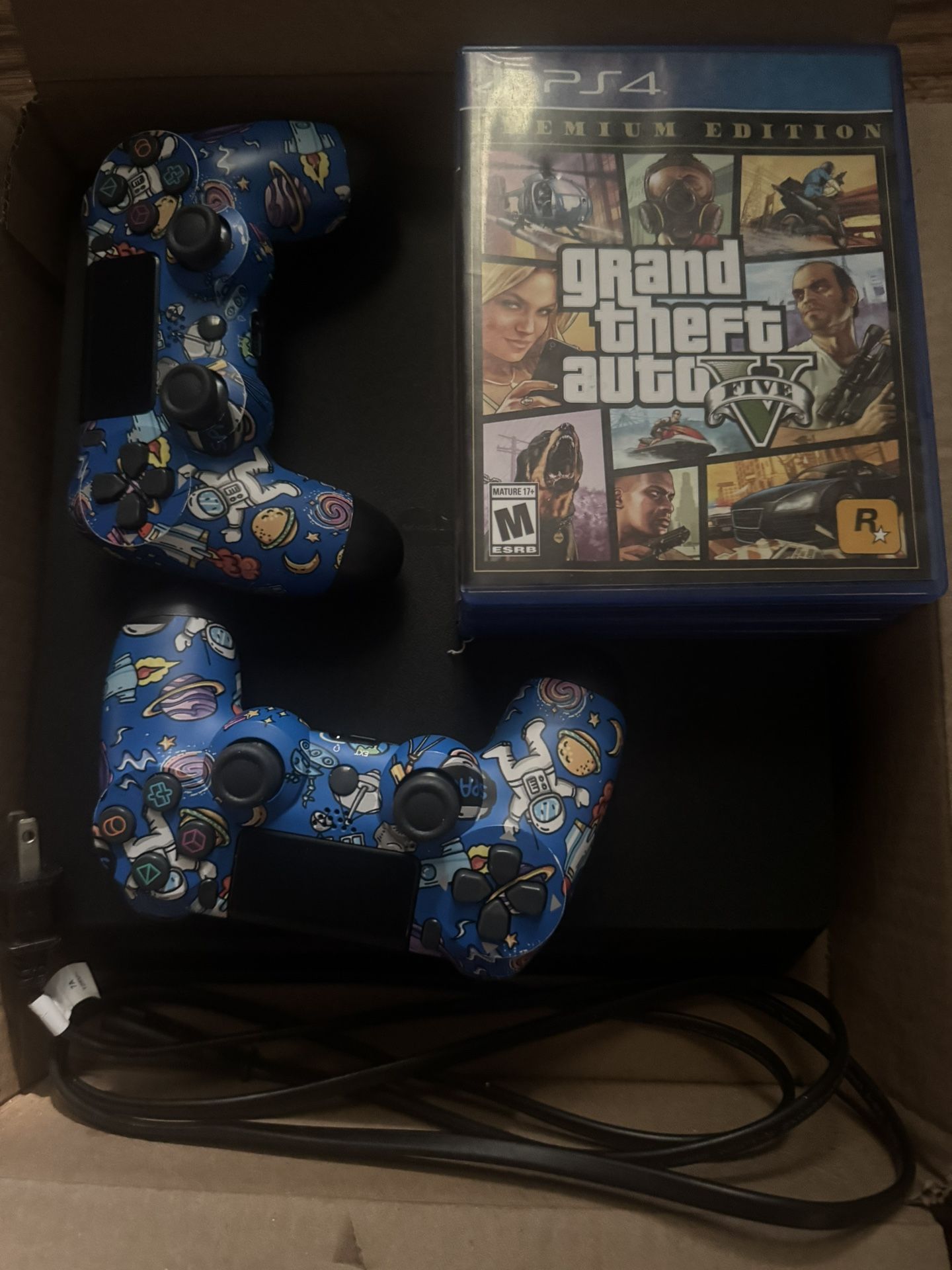 PS4 SLIM with 2 controllers, gta 5, 3 random games, and a power cord.