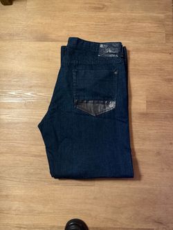 Robin's Jean dark wash jeans featuring their signature metallic leather long-flap back pockets.