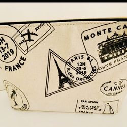 Large Makeup/cosmetic bag. 9” x  7” x 3” Lancôme Brand, With French black Icons all over ivory canvas fabric. Comes from a smoke free environment.  