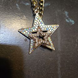 double star pendant on a chunky gold-toned chain