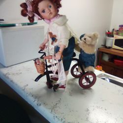 Porcelain Doll Riding Her Bike