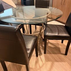 4 Dinning Chairs and a heavy Glass Table
