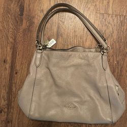 Beige coach leather purse with three departments inside fabric is red Auburn outside leather is beige in great shape