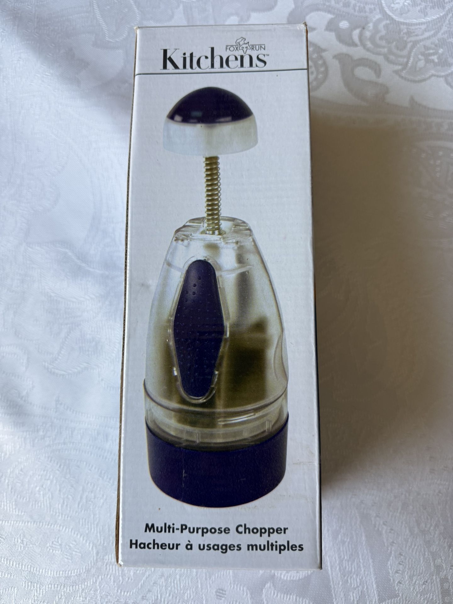 Kitchens Chopper. New. Still in box. Features a unique comfort top, automatically rotating stainless steel blades for easy chopping. 1-cup