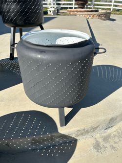 Fire pit made from washing machine tub with legs and handles painted with high temp BBQ paint.   Just add firewood and enjoy your outdoor fireplace ca