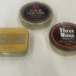 Collection of three vintage metal tobacco tins from UK manufacturers.