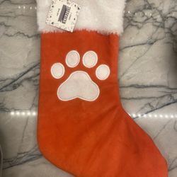 Christmas stocking with dog pawprint. 16” new with tag. Gift giving condition. 