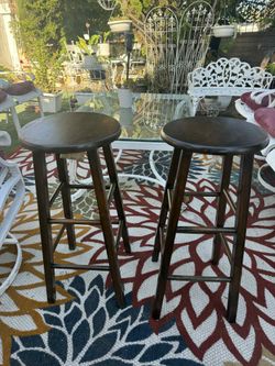 Set of two bar stool has been stained color dark brown are real wood