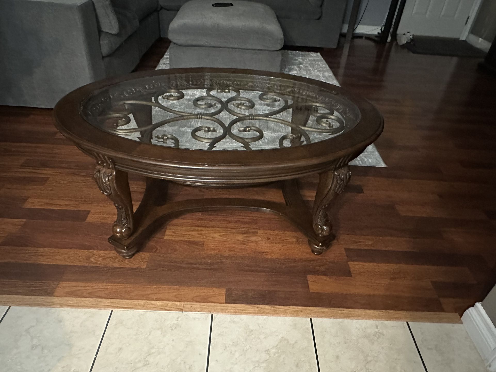 Coffee Table Dark Brown, Oval Glass On Top, Solid Wood. Size 48” Long x 34” Wide x 20” High.