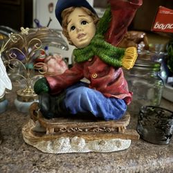 Boy Riding A Sled 