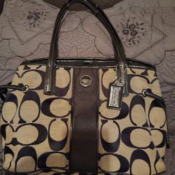 Coach, Color Black With Light Brown, Has A lot Of Space In Side The Purse