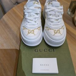 Authentic Gucci white leather sneakers with gold flake detailing (