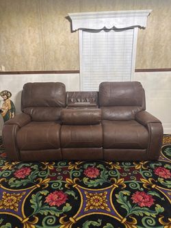 Brown Leather Reclining Sofa with Console and matching loveseat