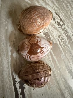 Vintage Hand Carved Tiger Cowrie Shells - Set of 3 Hand-carved tiger cowrie shells come in a set of three unique designs. One shell has the Lord's P