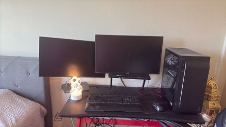 Computer with two monitors, keyboard, desk, and chair—all in very good condition.