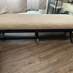 Upholstered Bench  60”L x 19”D x 18”H with solid wood base. Grey upholstery $75. Pick up in Palm Bay.