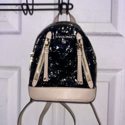 Michael Kors Brooklyn Logo Embossed Patent Extra Small Convertible Crossbody Backpack.