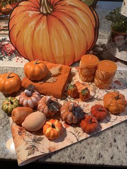 23 pc set. 3 pumpkins are ceramic, and the two salt and pepper are ceramic too. 4 pumpkin placemats. One has a water mark. 40.00 firm