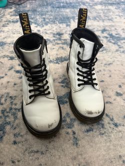 White & black Dr. Martens 1460 T boots.