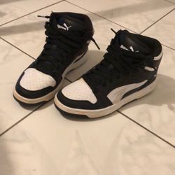 Black and white Puma High tops