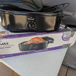 Rival 14 quart roaster oven with bottom rack. Like new in box.