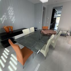 Glass dining table with leather chairs