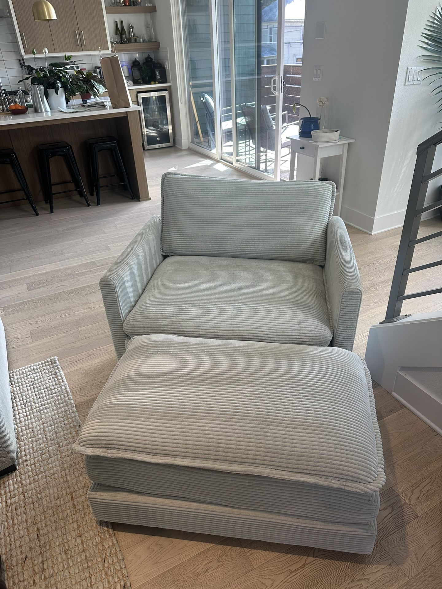 Upholstered corduroy armchair with ottoman