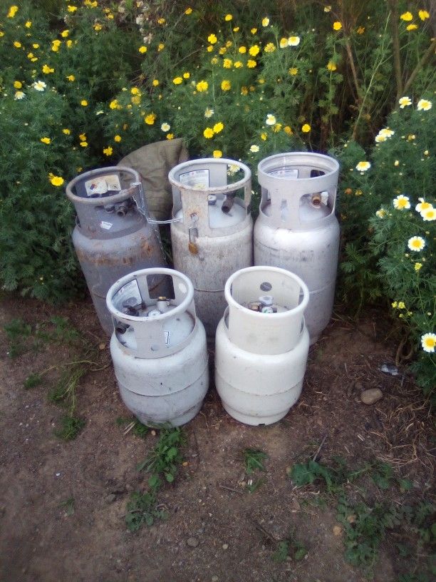 Three Forklift Propane Tanks And Two Smaller Industrial  Propane Fuel Tanks