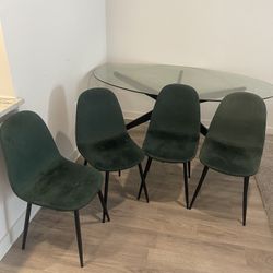 Oval Shaped Table With Green Chairs 