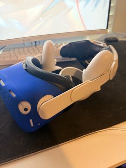 Meta Quest 2 VR Headset with Blue Silicone Cover and adjustable headset.