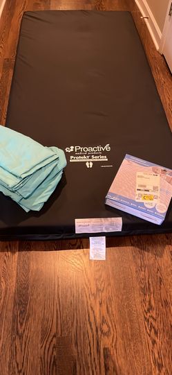 XL bed with 2sets of sheets and mattress pad