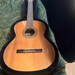 Old Used School Band Acoustic Guitar Along With The Casing For It 
