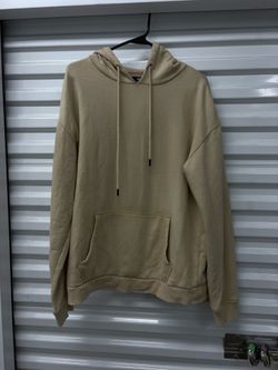 The NOVA MEN Men's Beige Solid Pullover Hoodie is a stylish and comfortable activewear piece perfect for men. This hoodie features a drawstring closur