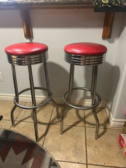 Two retro style red barstools