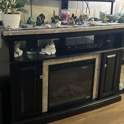 Black tv Stand With Some  Beige  marvel & Fire Place 