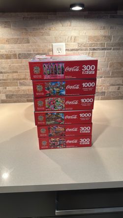 6 boxes of Coca Cola themed puzzles