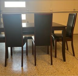 Beautiful dark brown with four matching chairs and a matching bench.