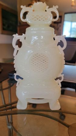 Chinese white jade carved lidded vase featuring intricate pierced decorations (traforo) and dragon-headed loose ring handles