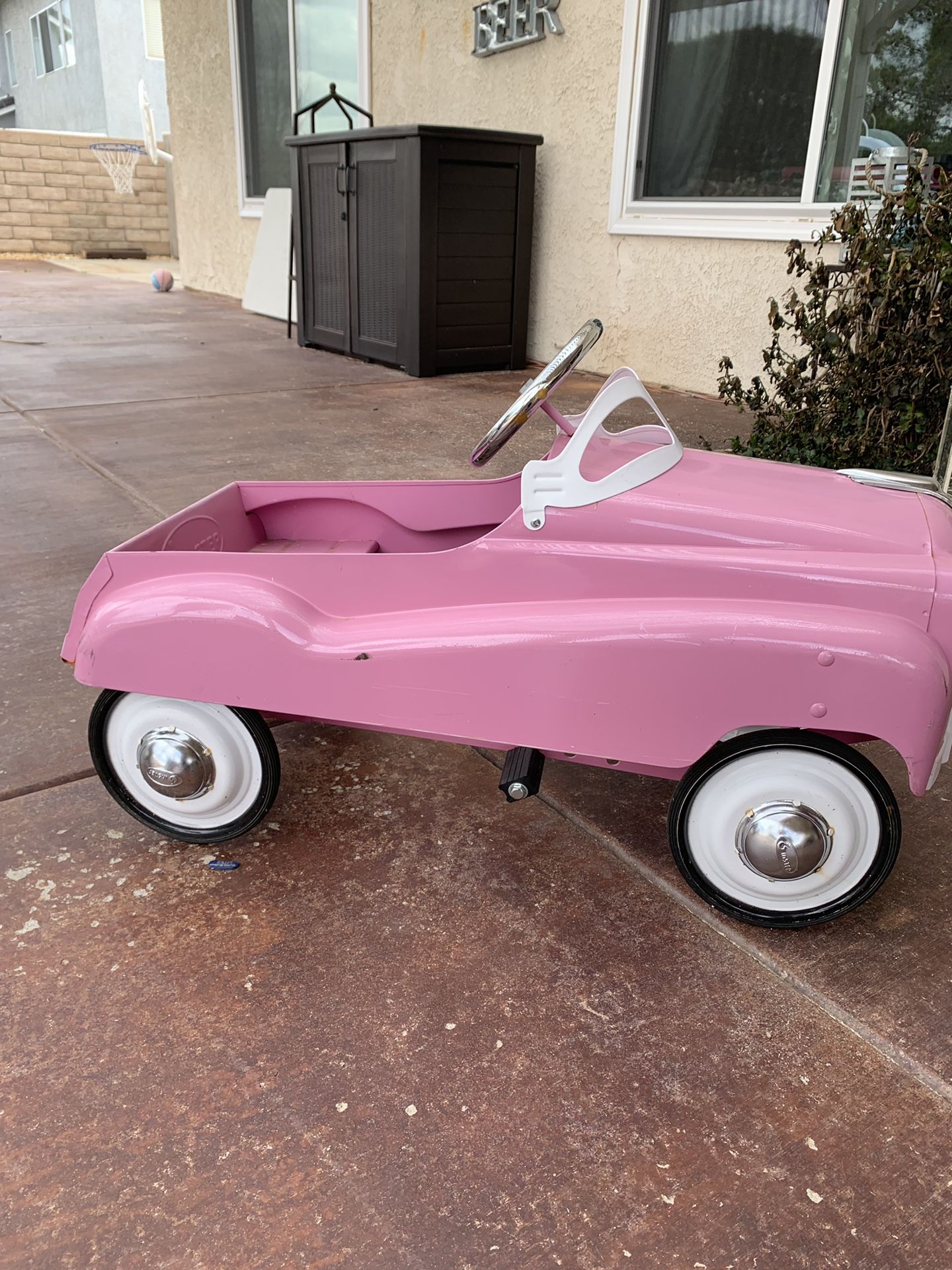 Pink pedal car