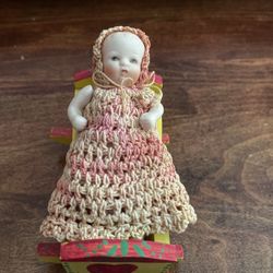 Antique Doll In A Rocker Bed