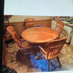 Wooden kitchen table with four chairs in fair condition no issues 42” across the top and approximately 32” from floor to top of table No cracks just g