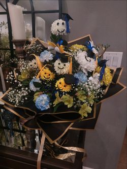 Graduation flower arrangement  with some artificial flowers